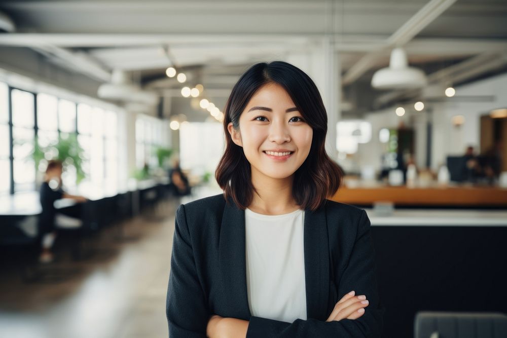 Happy japanese woman smiling standing portrait office. 