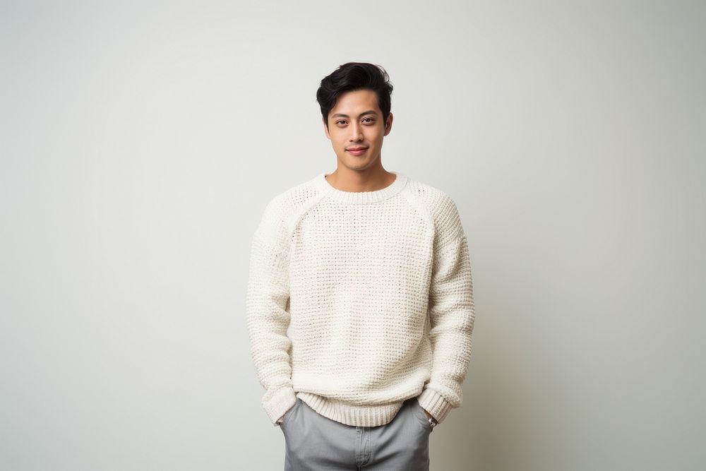 A model asian guy wearing crochet purl knit sweater white background outerwear happiness. AI generated Image by rawpixel.