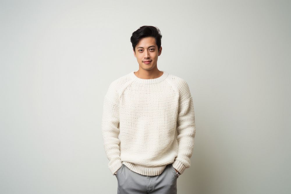 A model asian guy wearing crochet purl knit sweater white background outerwear happiness. 