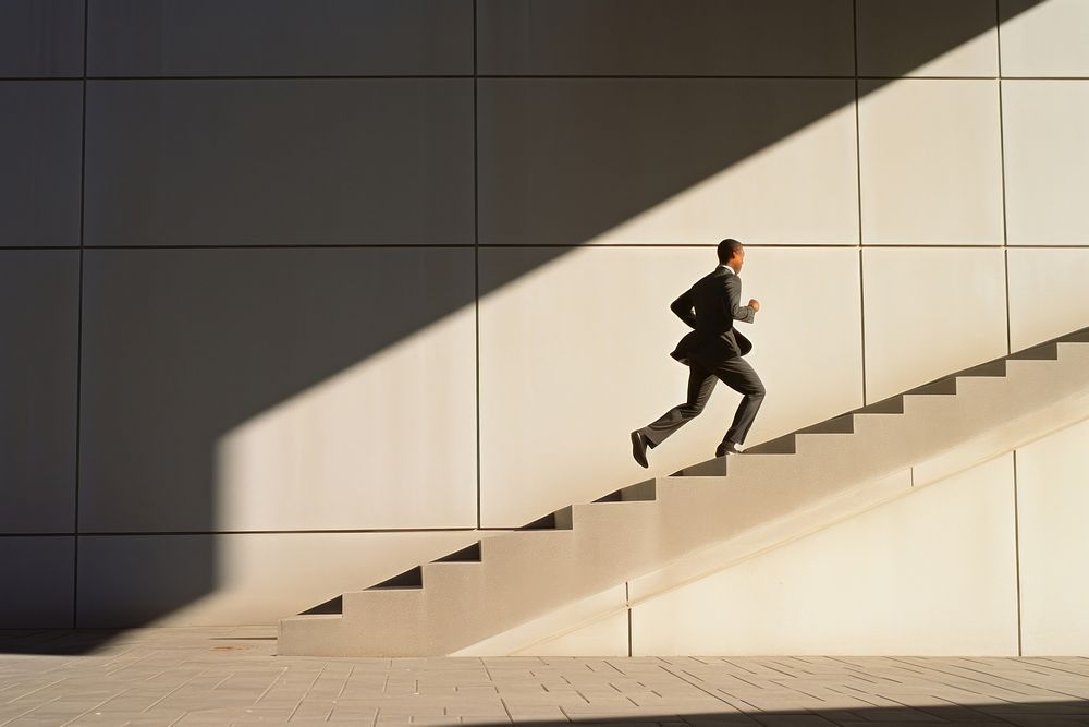 Businessman running architecture staircase outdoors. AI generated Image by rawpixel.