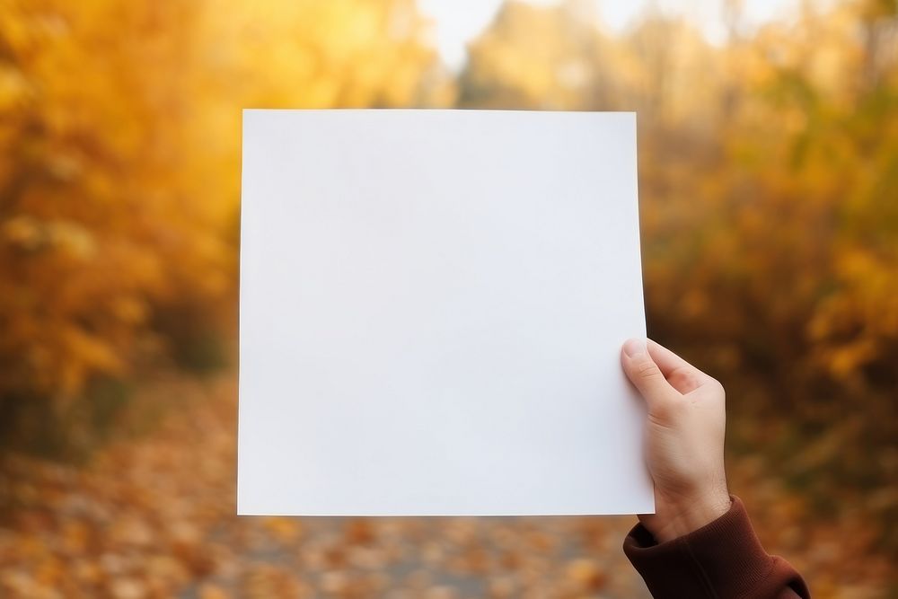 Holding poster paper autumn photo hand. AI generated Image by rawpixel.