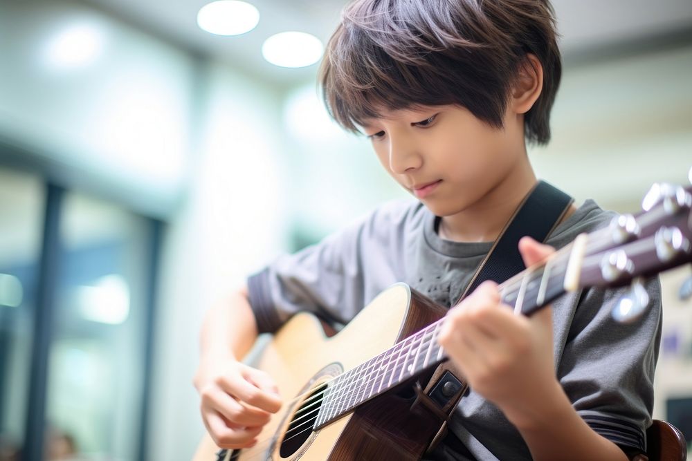 Boy playing guitar music musician performance. AI generated Image by rawpixel.