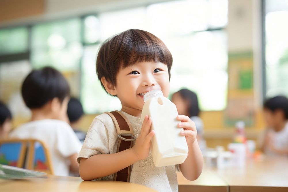 Kid drinking milk carton classroom child refreshment. AI generated Image by rawpixel.