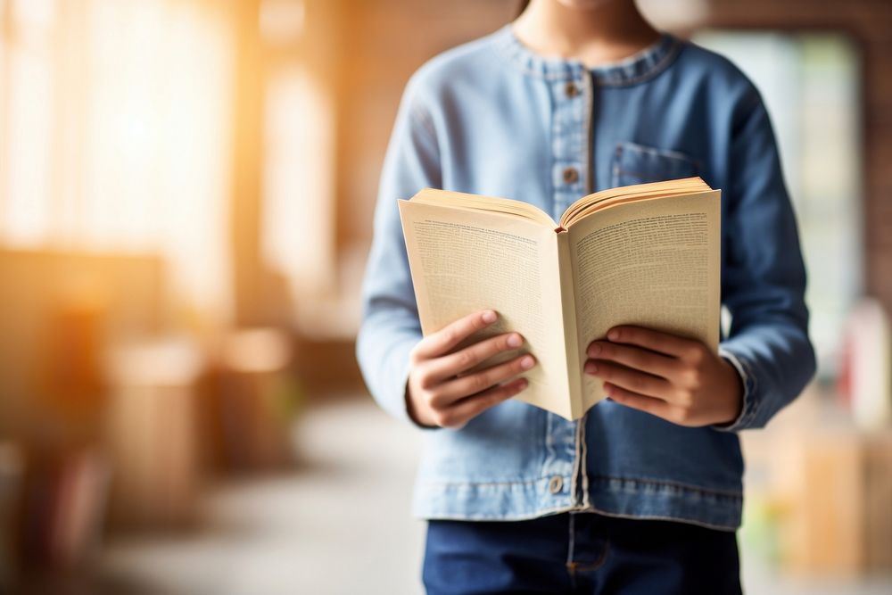 Kid standup holding book publication reading intelligence. AI generated Image by rawpixel.
