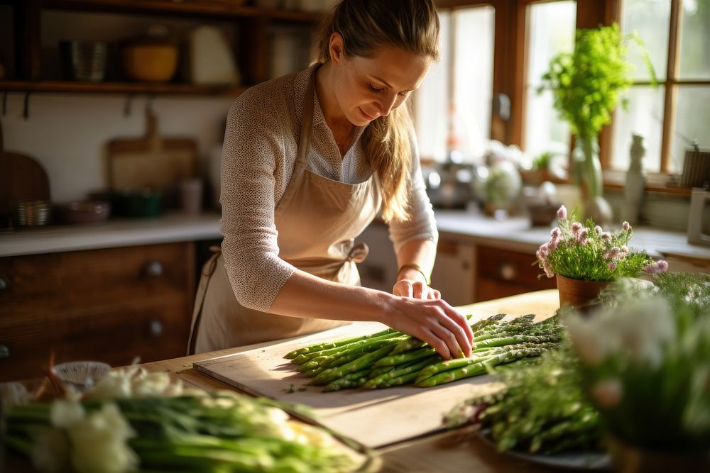 Female cooking asparagus vegetable adult plant. AI generated Image by rawpixel.