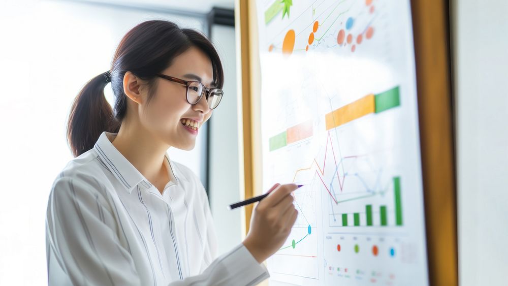 photo of asian women wearing glasses writing a chart on a whiteboard. AI generated Image by rawpixel.