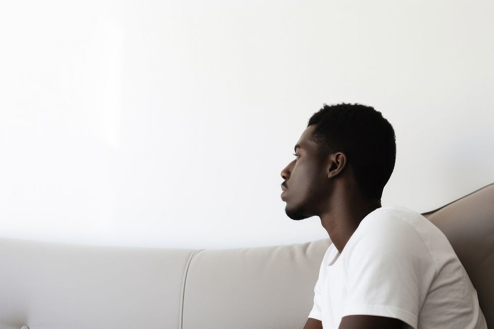 Depressed adult sitting sofa contemplation. AI generated Image by rawpixel.