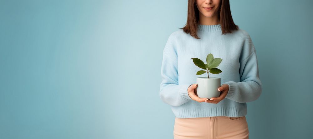 Woman holding a potted plant sweater photo blue. AI generated Image by rawpixel.