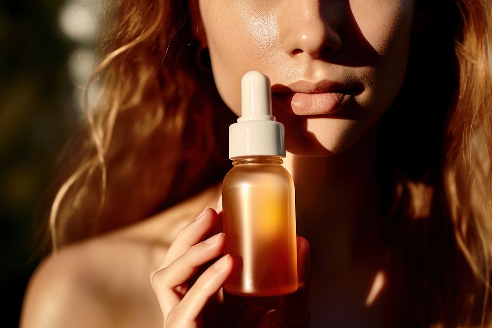 Dropping bottle cosmetics perfume holding. AI generated Image by rawpixel.