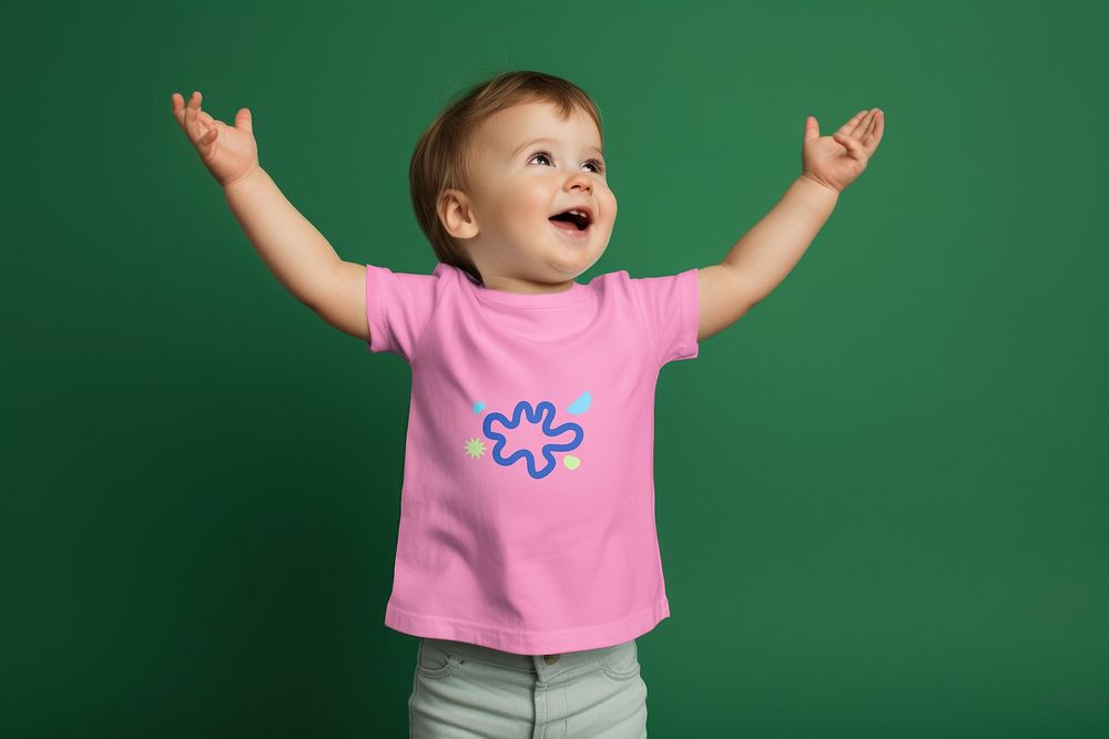 Cheering toddler in pink t-shirt