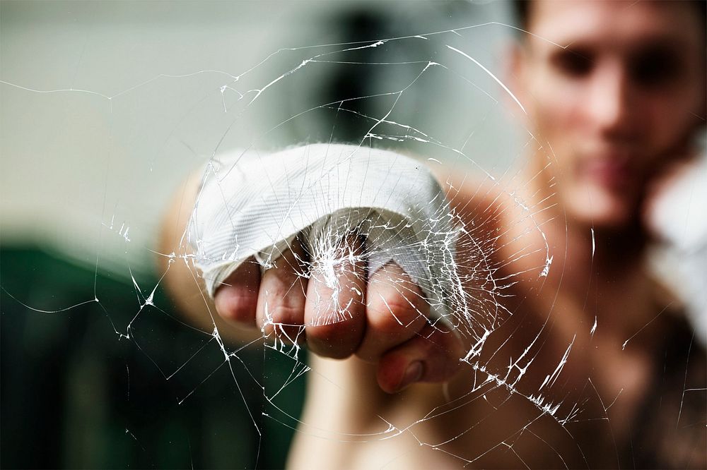 Man punching glass, cracked effect