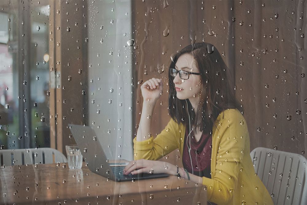Woman in a library with rain effect