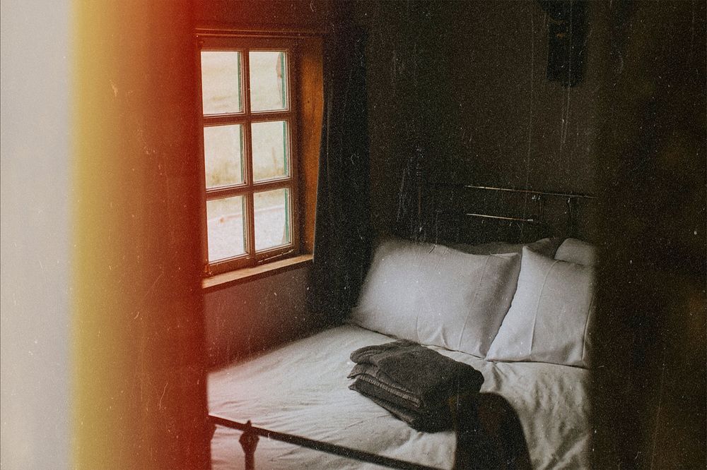 Cozy hotel room photo with film grain effect
