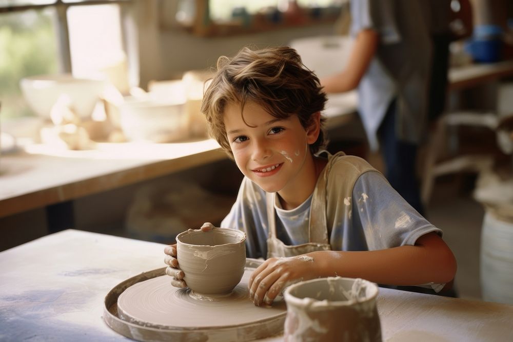 Young boy making ceramic coffee cup mug. AI generated Image by rawpixel.