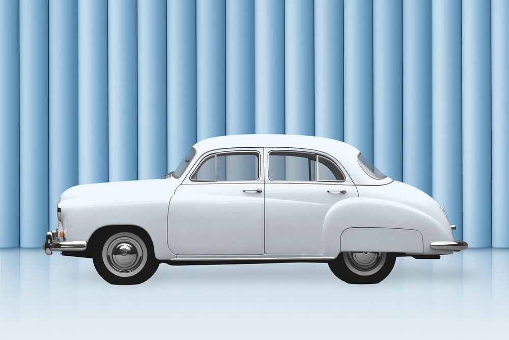 White vintage car on blue backdrop