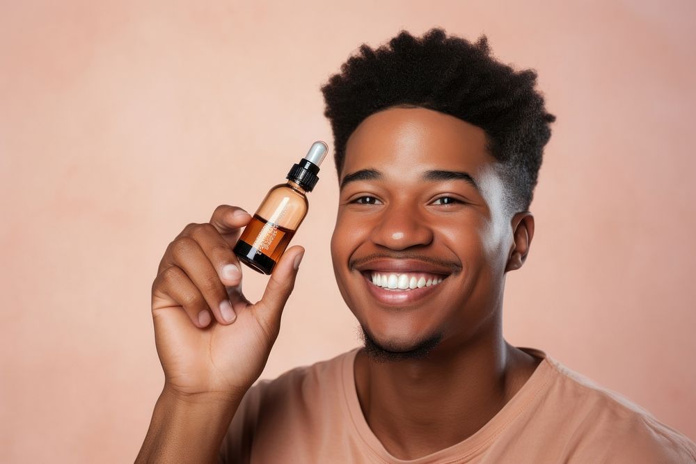 Smiling man cosmetics bottle face. 