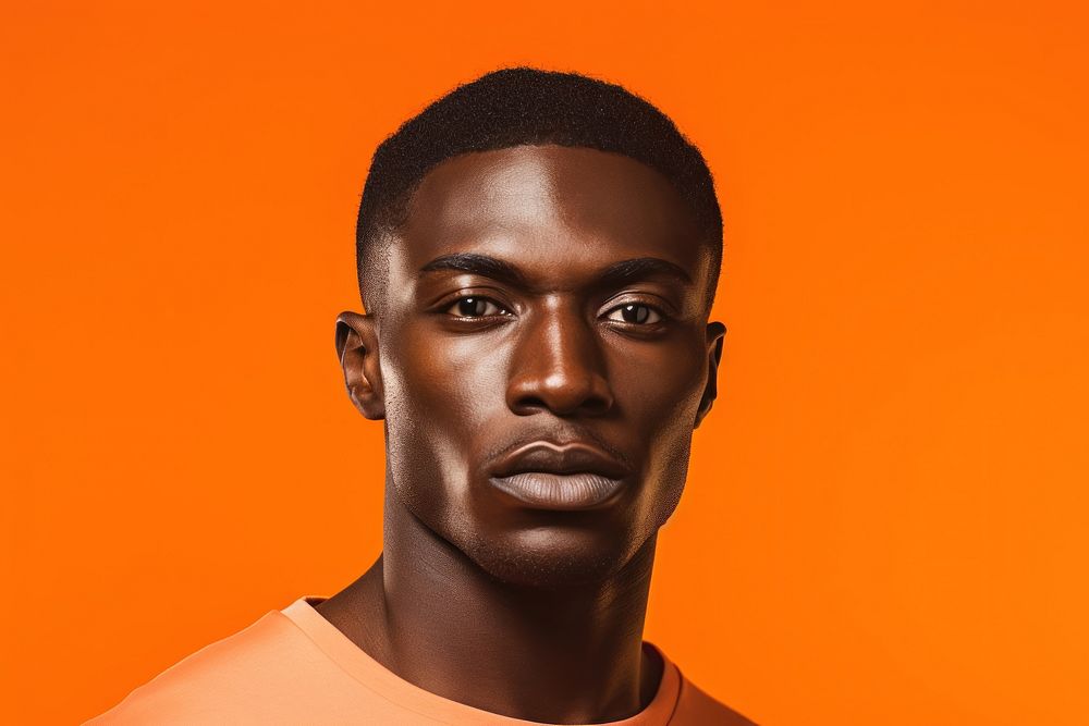 Affican man portrait photo orange background. 