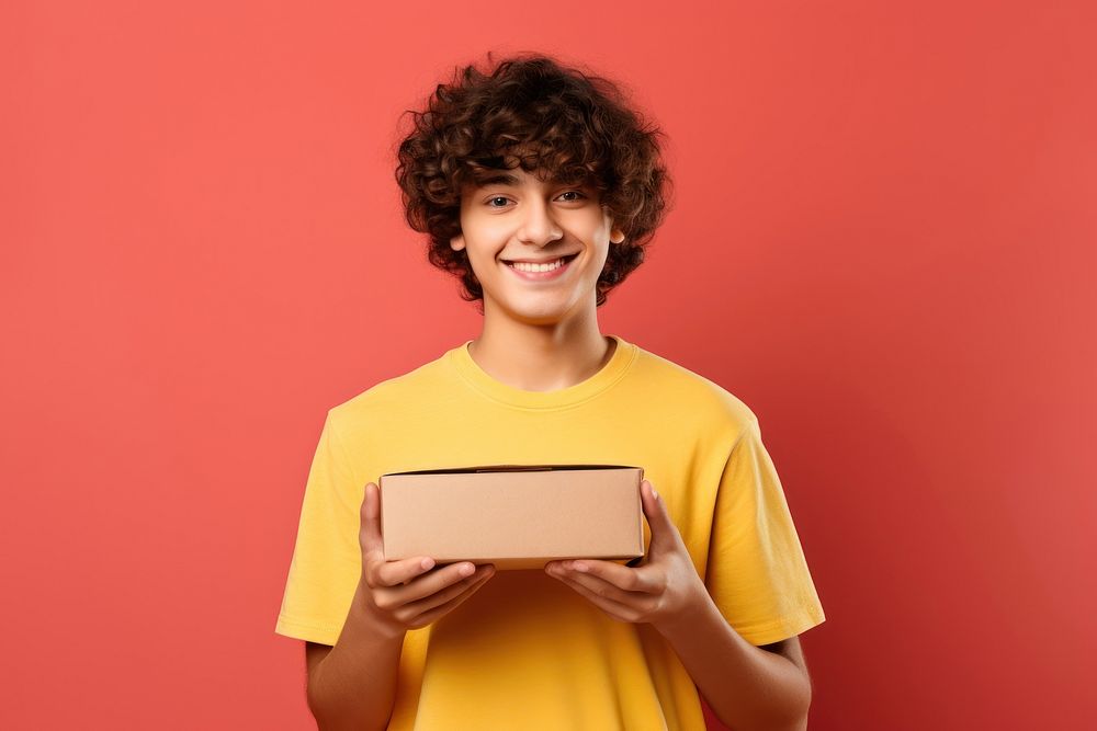 Teenage boy holding a food box. AI generated Image by rawpixel.