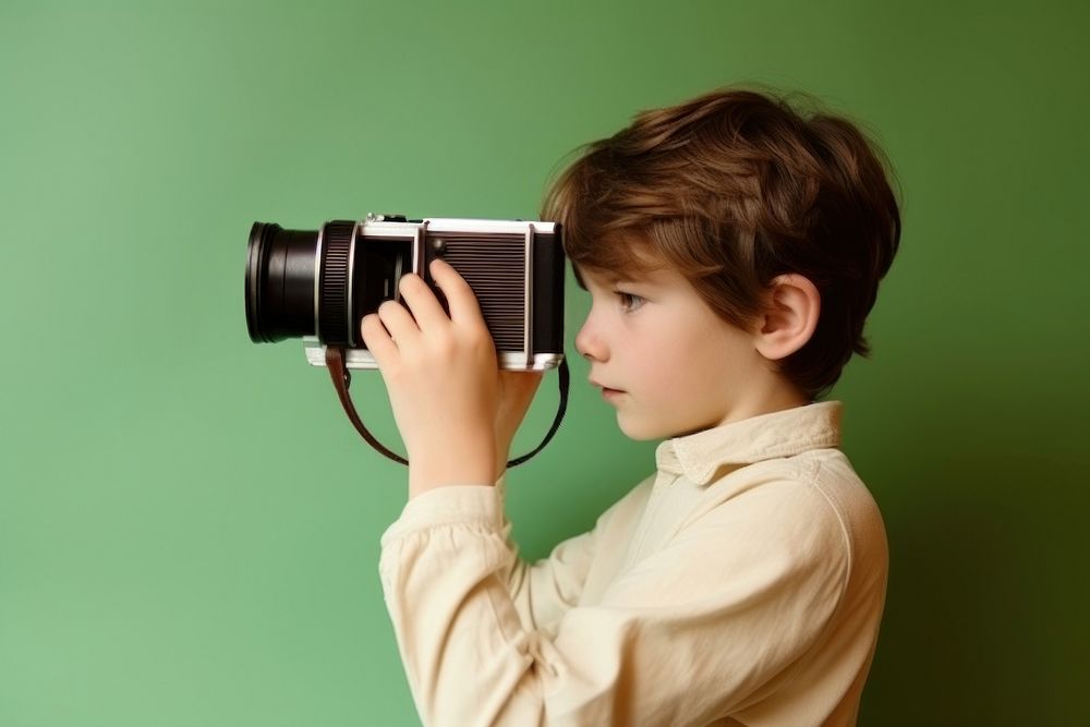 Young boy with film camera. AI generated Image by rawpixel.