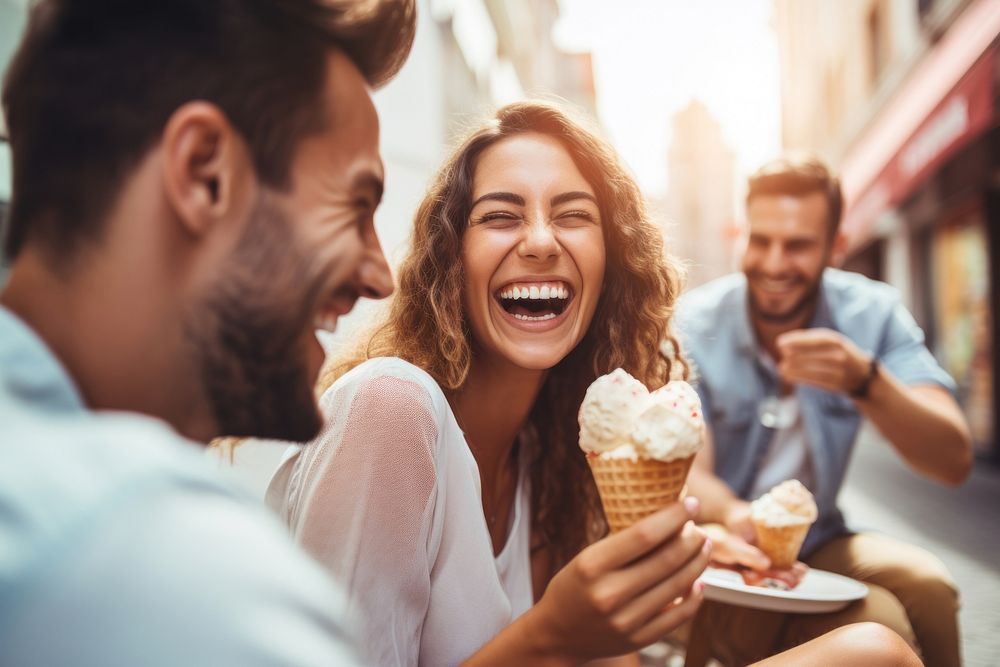 Eating laughing outdoors dessert. 