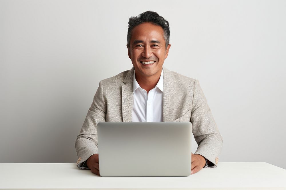 South east asian businessman computer sitting laptop. AI generated Image by rawpixel.