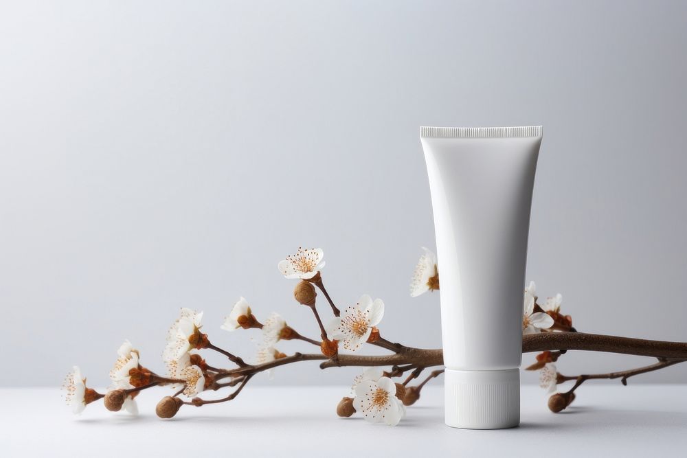 Cosmetic lotion cream bottle branch flower plant. AI generated Image by rawpixel.