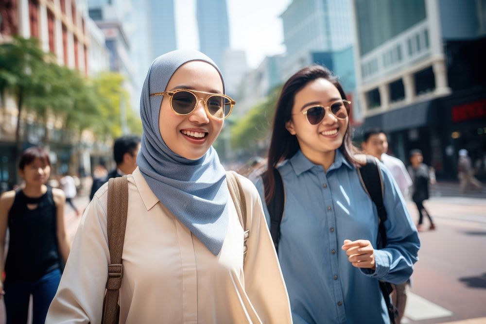 Young female muslim tourists walking street scarf. AI generated Image by rawpixel.