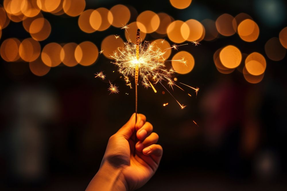 Holding sparkler sparks hand illuminated. AI generated Image by rawpixel.