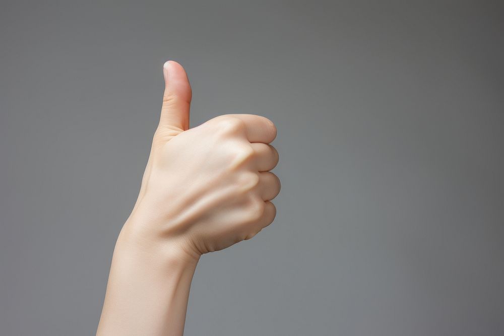 Woman showing thumbs finger hand studio shot. AI generated Image by rawpixel.