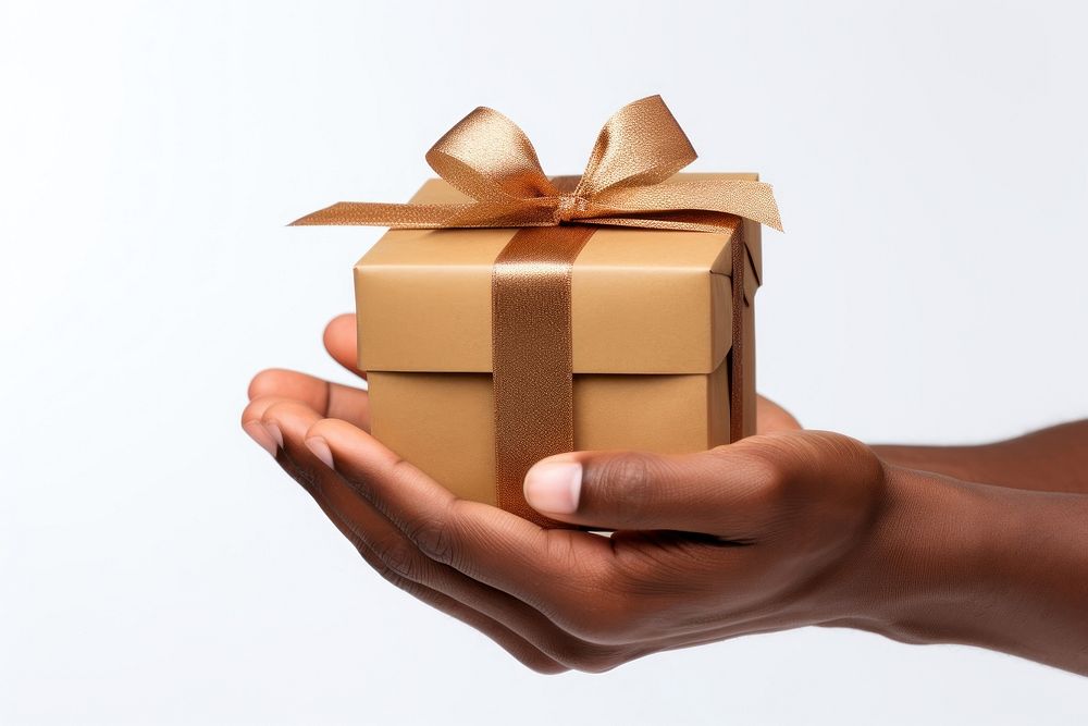 Brown hand holding out gift box white background celebration. AI generated Image by rawpixel.