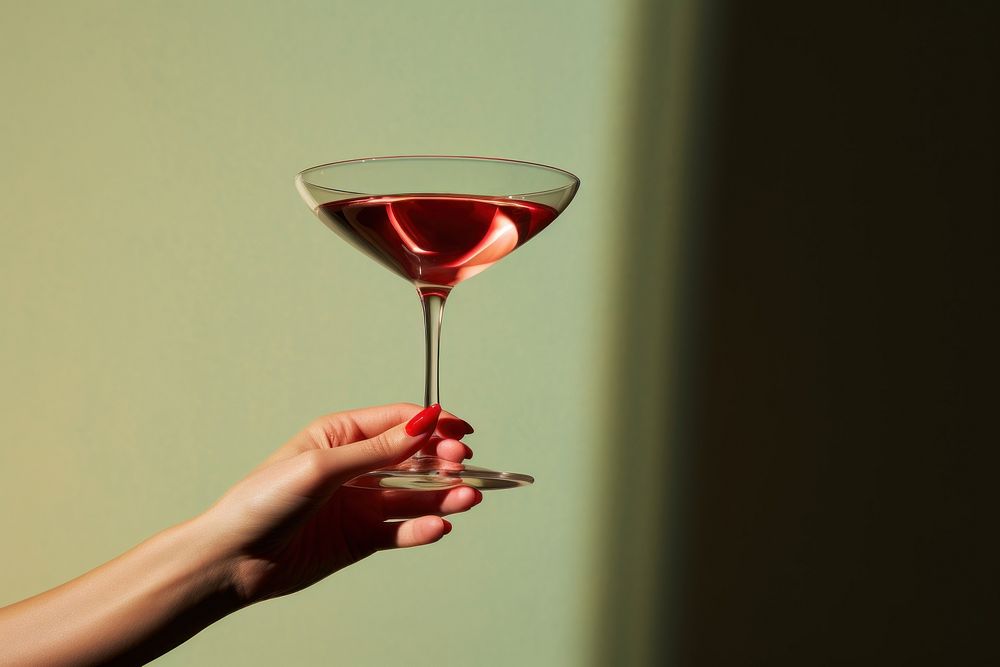 Martini glass cocktail holding drink