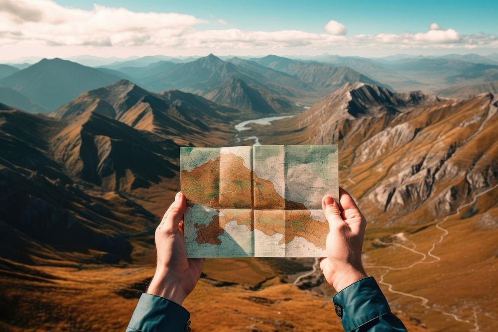 Holding a map landscape mountain hand. AI generated Image by rawpixel.