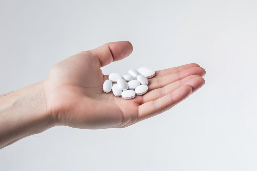 Hand holding medicine white pill medication. AI generated Image by rawpixel.