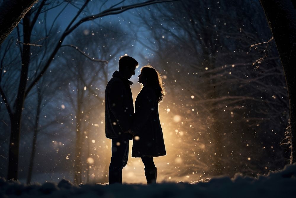 Couple outdoors snowing kissing