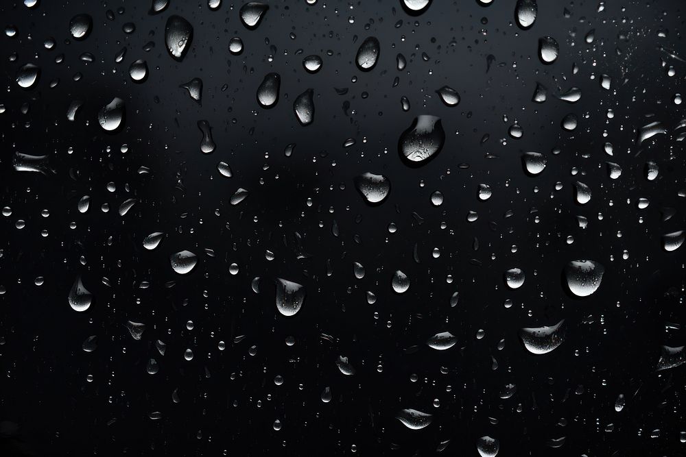 Water drops black backgrounds rain. AI generated Image by rawpixel.