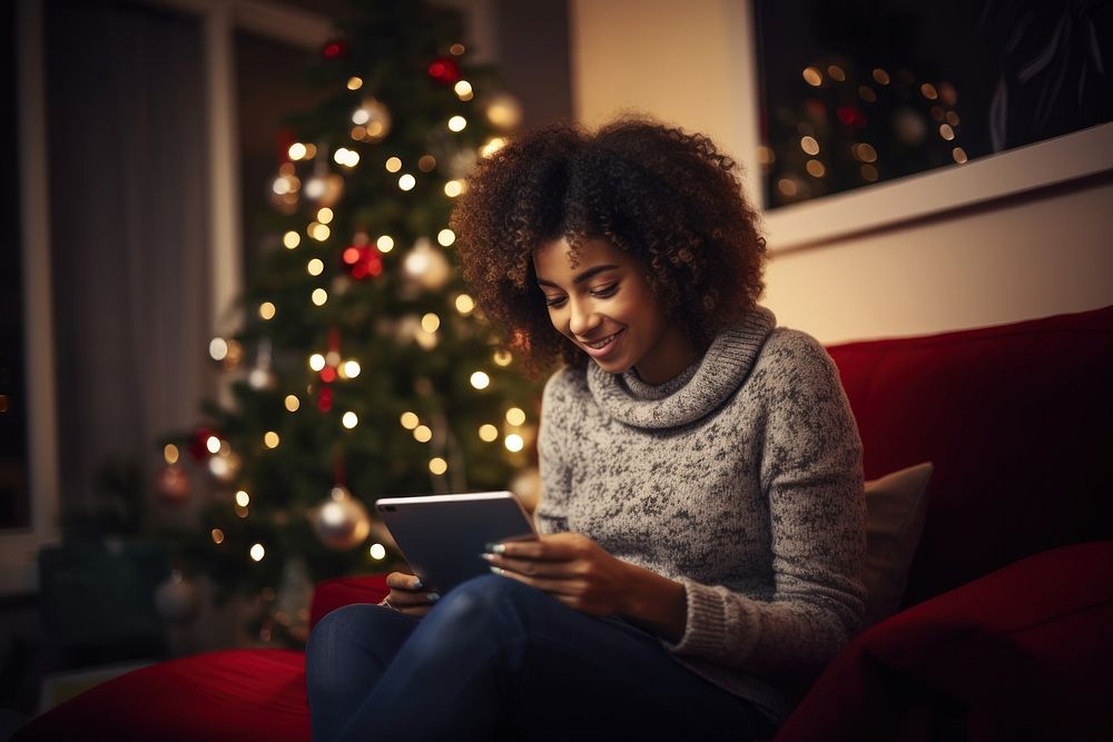 Afro-American woman christmas computer sitting. AI generated Image by rawpixel.