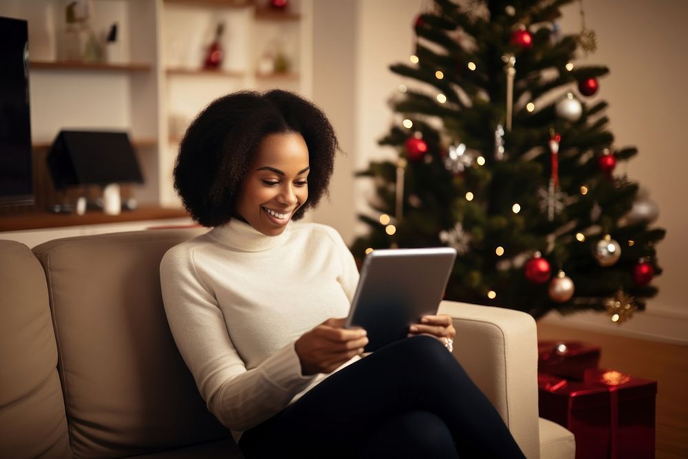 African American woman christmas sitting computer. AI generated Image by rawpixel.