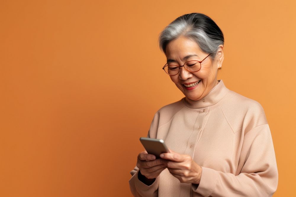 Old asian woman using phone glasses adult portability. AI generated Image by rawpixel.