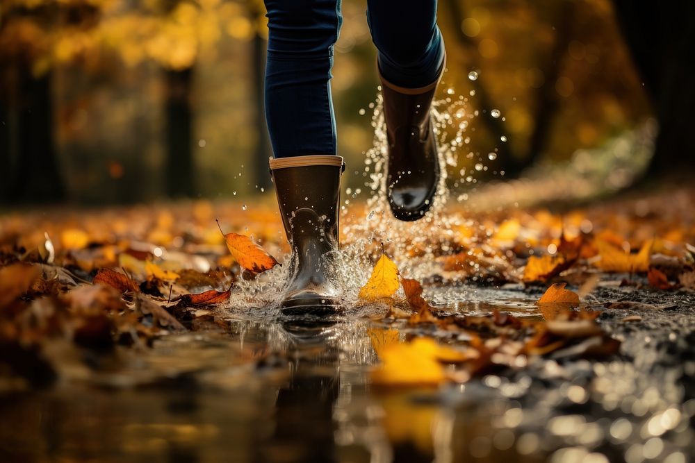Woman legs wearing rain boots autumn splashing walking. AI generated Image by rawpixel.