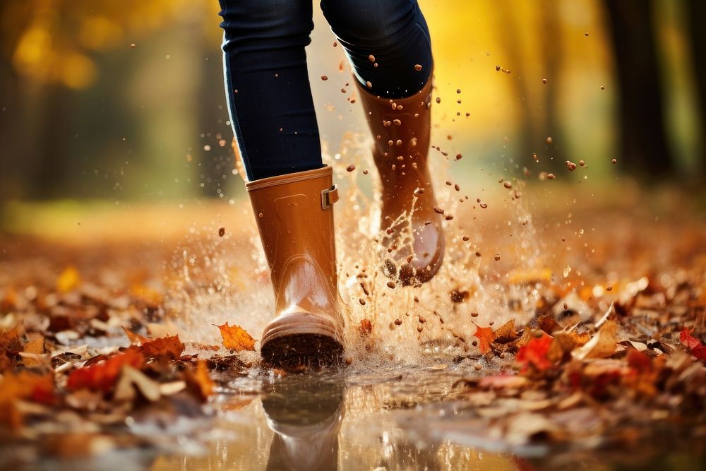 Woman legs wearing rain boots autumn splashing walking. AI generated Image by rawpixel.