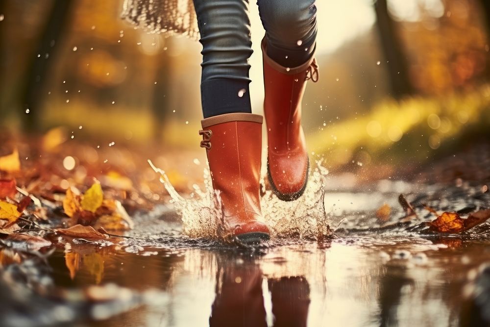 Woman legs wearing rain boots puddle footwear walking. AI generated Image by rawpixel.