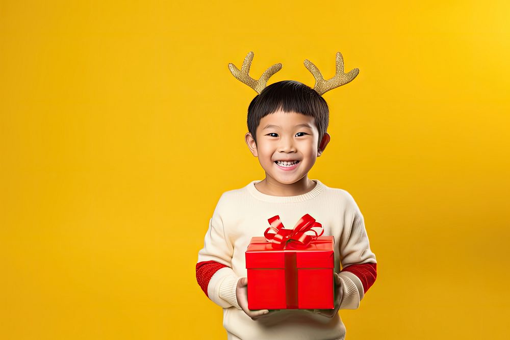 Asian boy sweater yellow gift. AI generated Image by rawpixel.