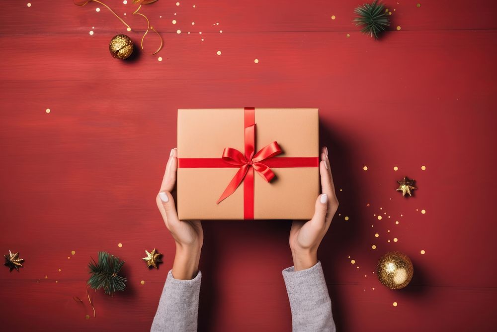 Christmas gift box christmas holding hand. AI generated Image by rawpixel.