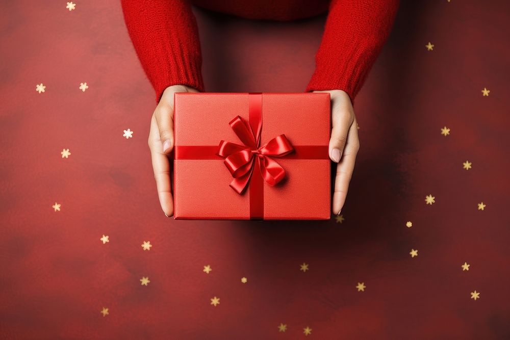Christmas gift box christmas hand red. AI generated Image by rawpixel.