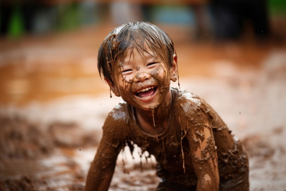 A little asian boy smile happy mud. AI generated Image by rawpixel.