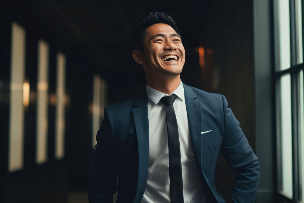 South east asian businessman laughing blazer adult. AI generated Image by rawpixel.