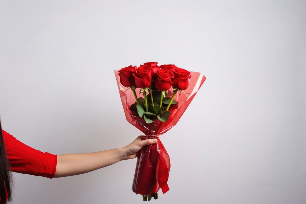 Hand holding red rose flower bouquet wrapped plant adult. AI generated Image by rawpixel.