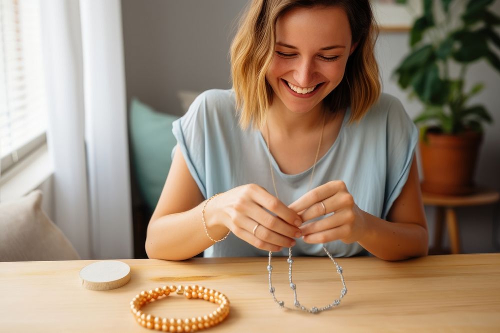 Making bead bracelet necklace jewelry smiling. AI generated Image by rawpixel.
