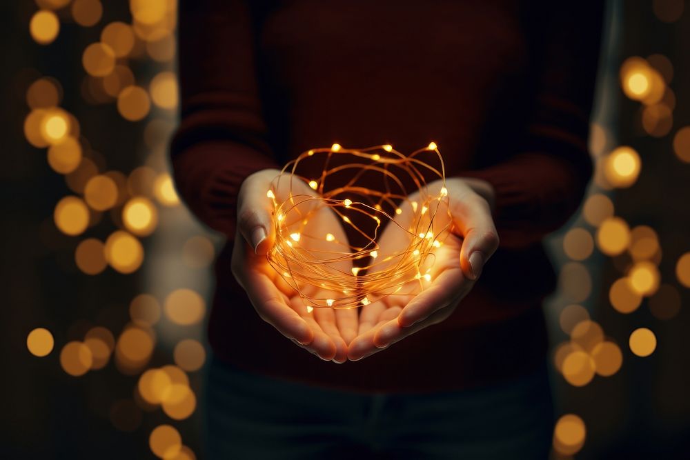 Christmas string lights christmas holding hand. AI generated Image by rawpixel.