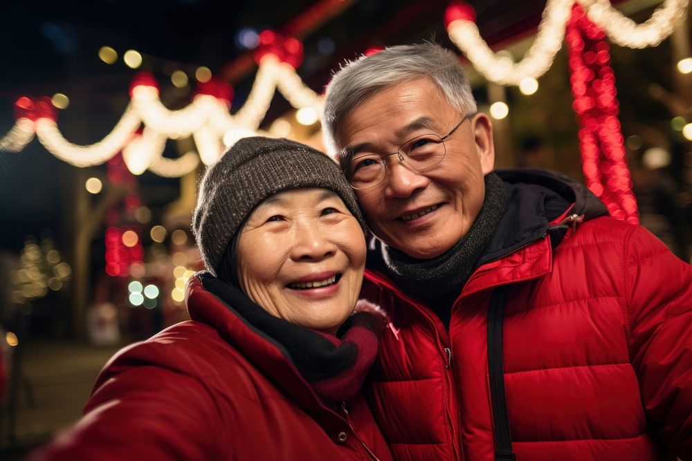 Old asian couple taking a selfie christmas portrait adult. AI generated Image by rawpixel.
